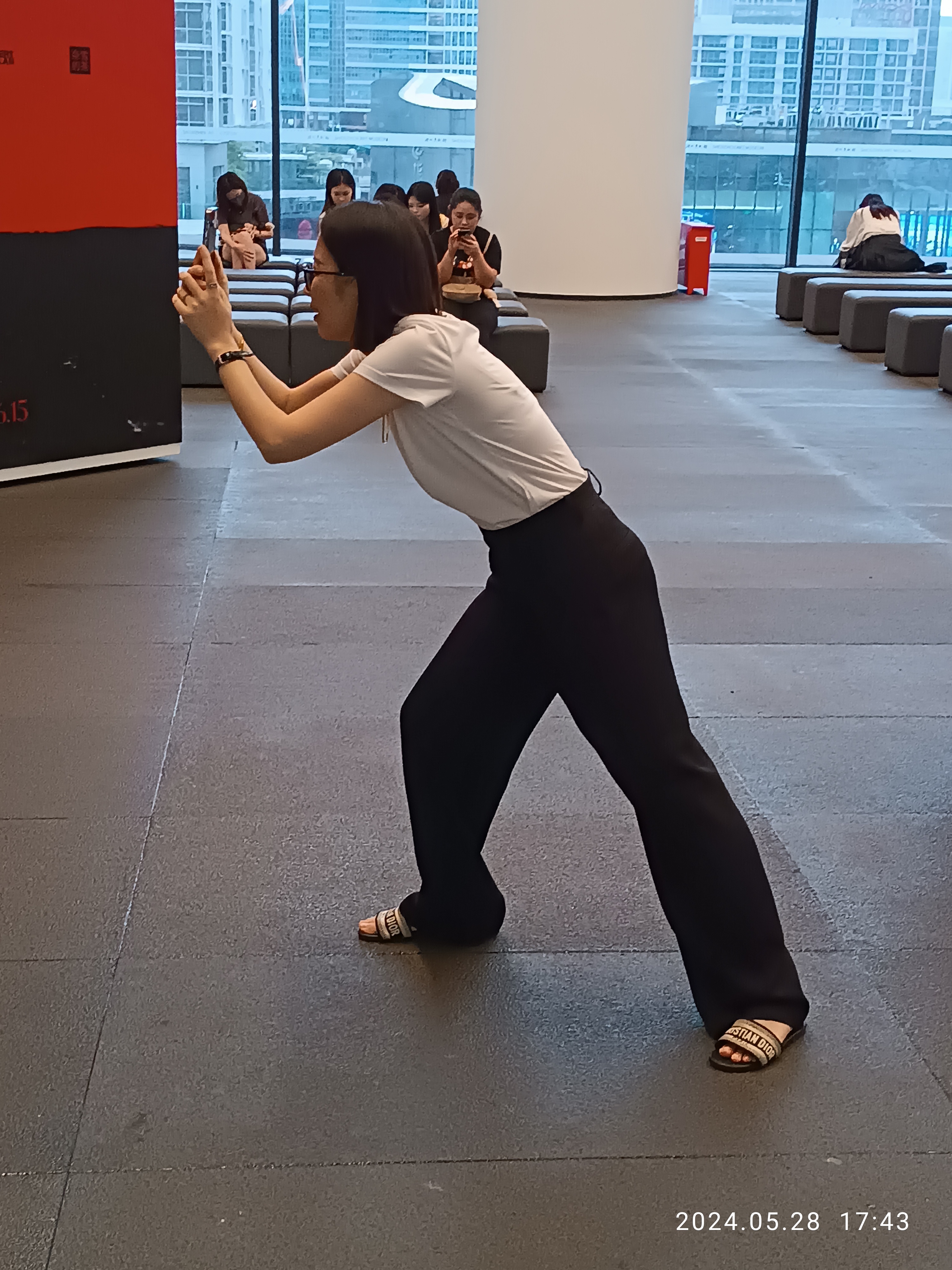 Museum visitor using a smartphone to photograph an artwork