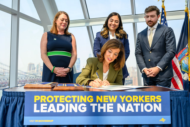 Governor Kathy Hochul holding the executive order for New York's hyperscale data center pause