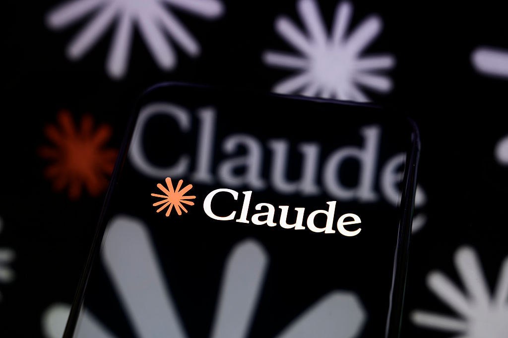 Claude logo on a smartphone screen in the TechCrunch report about auto mode