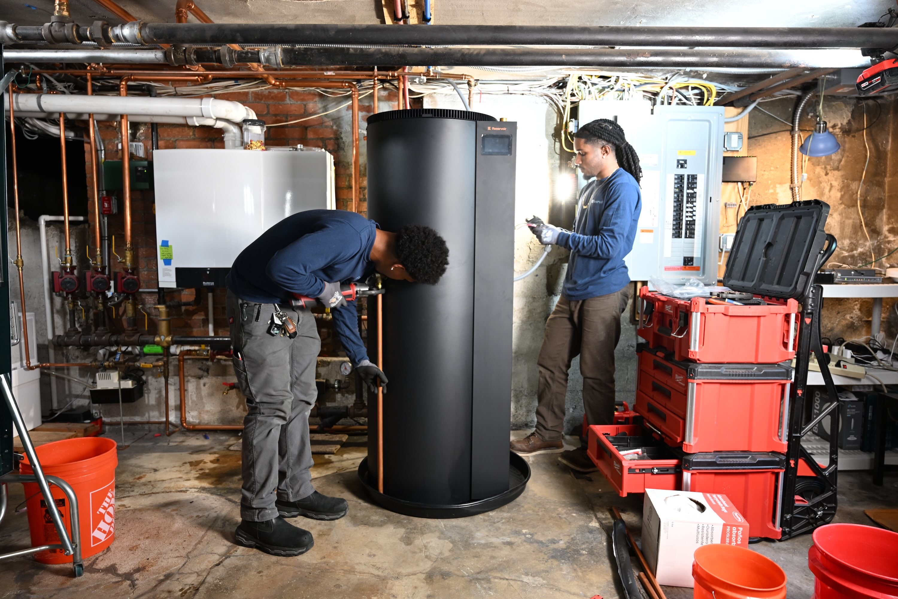Two plumbers installing a Reservoir water heater
