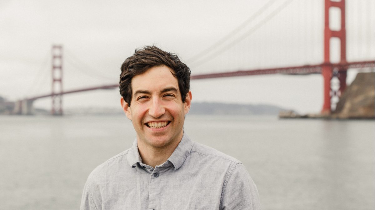 Relay founder Jacob Bank outdoors with the Golden Gate Bridge behind him