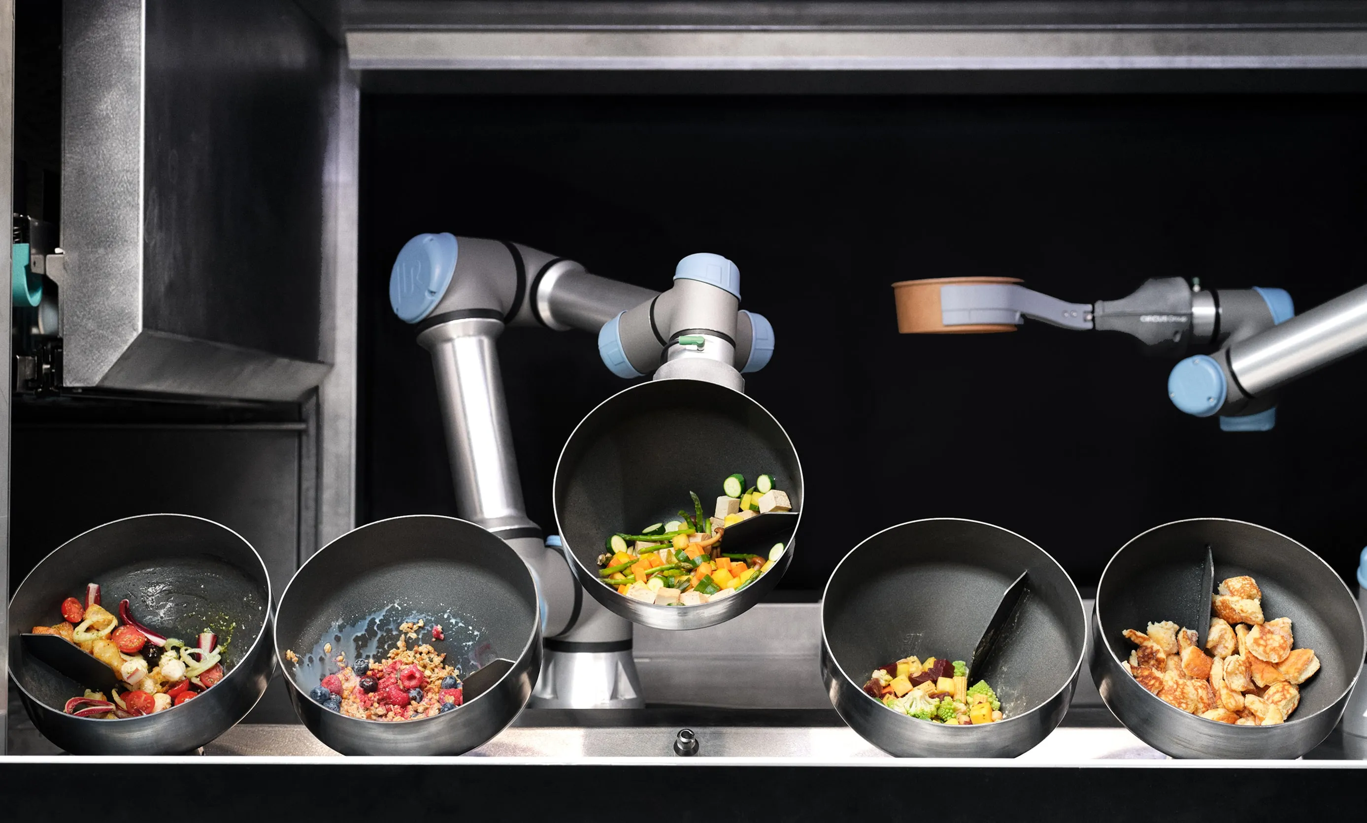 Circus CA-1 autonomous cooking robot preparing several meals