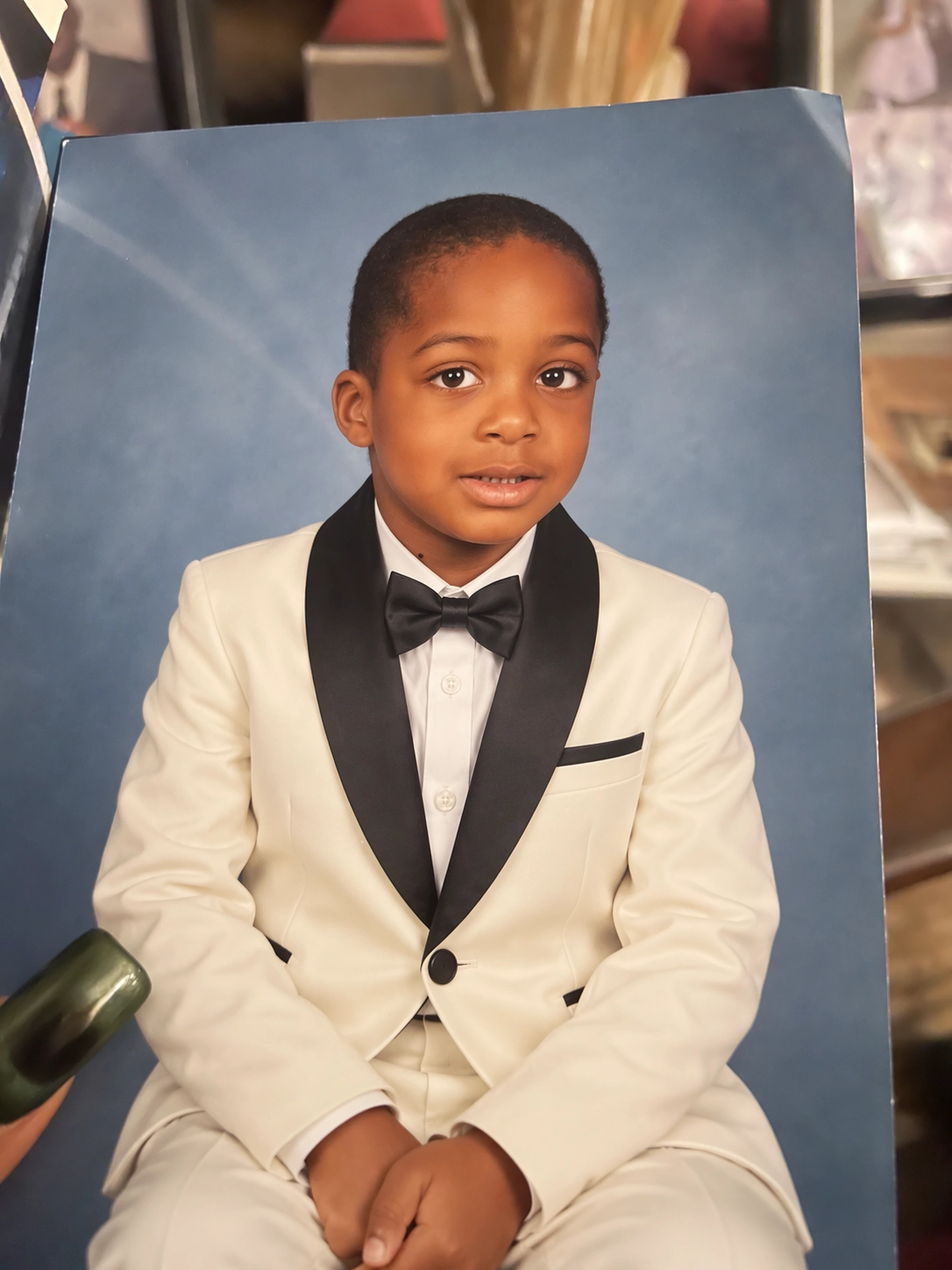 OpenAI supplied edited portrait example showing a child in a tuxedo against a blue backdrop