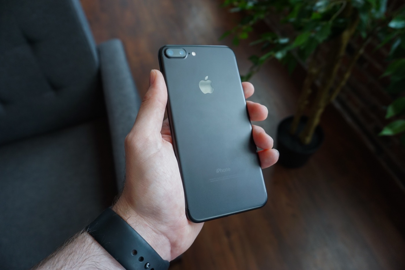 A black smartphone held in a hand